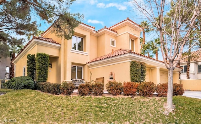 mediterranean / spanish house featuring a front yard