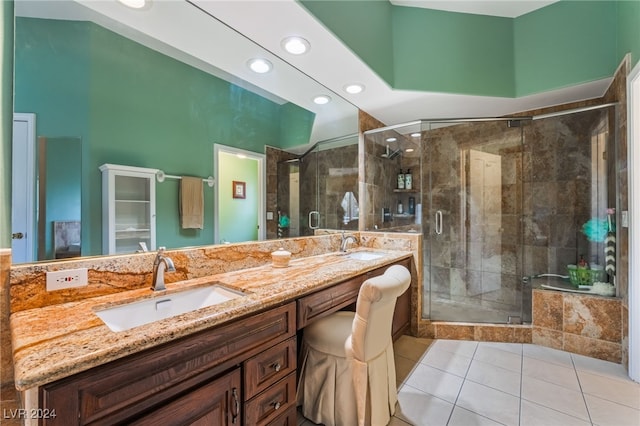 bathroom featuring vanity, an enclosed shower, and tile patterned flooring