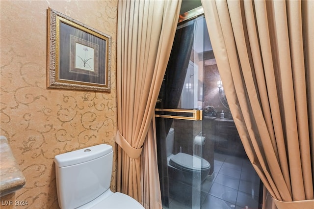 bathroom featuring toilet and tile patterned flooring