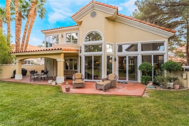 back of house with a patio and a yard