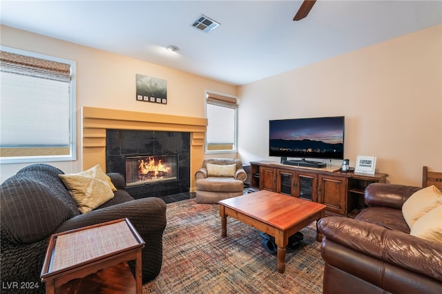 living room with a tiled fireplace