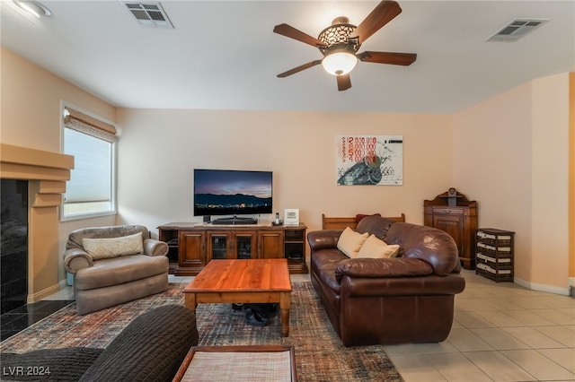 living room with ceiling fan and tile patterned floors