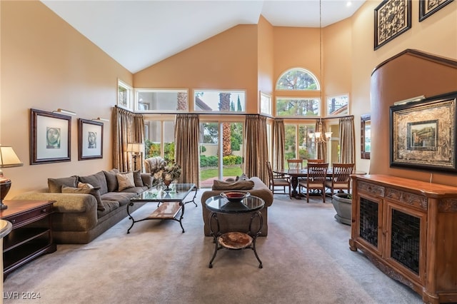 carpeted living room featuring a notable chandelier and a high ceiling