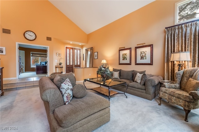 living room featuring plenty of natural light, carpet flooring, and high vaulted ceiling