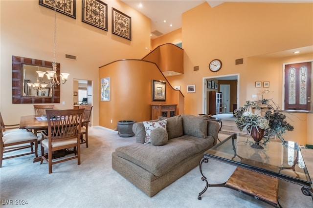 living room featuring an inviting chandelier, carpet floors, and a high ceiling