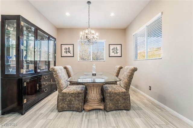 dining space with recessed lighting, baseboards, and a chandelier