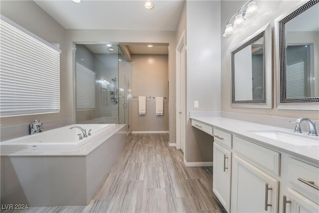 bathroom with vanity and independent shower and bath