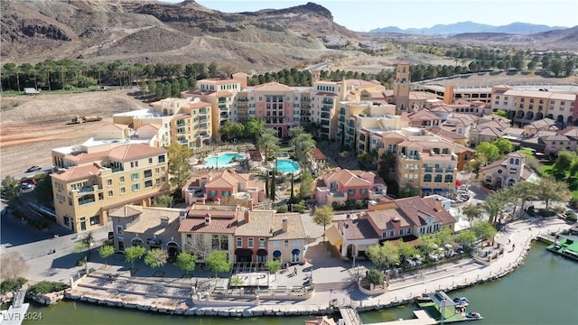 drone / aerial view featuring a water and mountain view