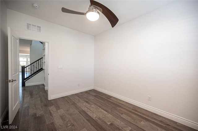 unfurnished room featuring ceiling fan and dark wood-type flooring