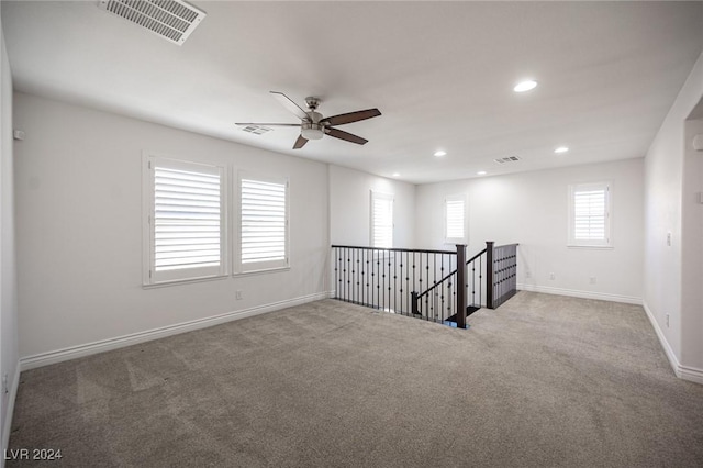 carpeted empty room with ceiling fan