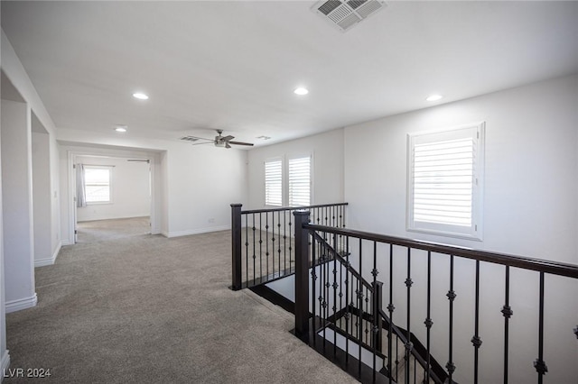 hallway with light carpet and plenty of natural light