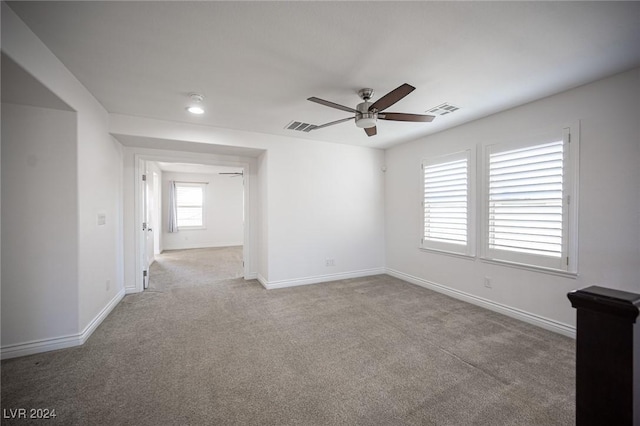 unfurnished room featuring ceiling fan and light colored carpet