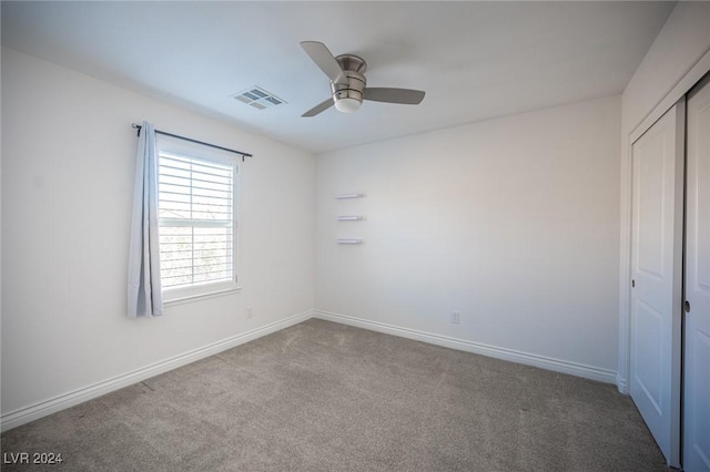 unfurnished room featuring ceiling fan and light colored carpet