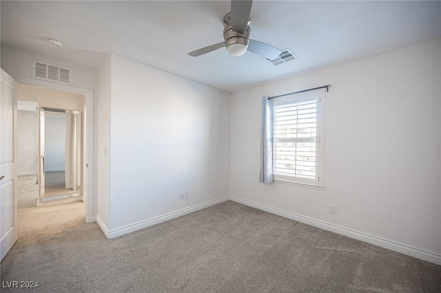 carpeted empty room with ceiling fan