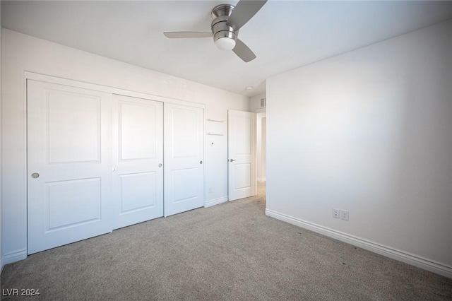 unfurnished bedroom featuring carpet flooring, ceiling fan, and a closet