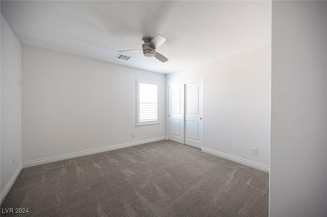 unfurnished room featuring ceiling fan and carpet floors