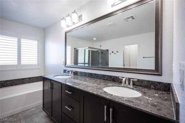 bathroom with tile patterned flooring, vanity, and independent shower and bath