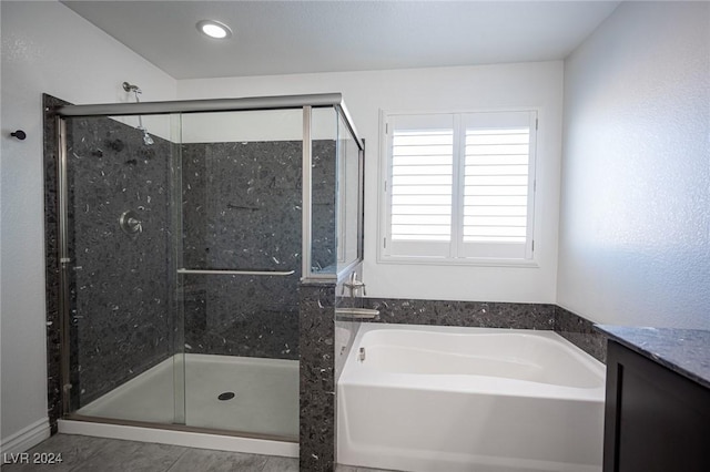 bathroom featuring vanity and independent shower and bath