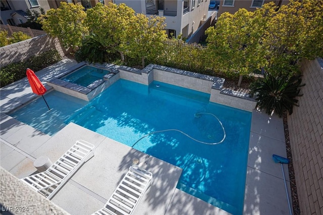 view of pool featuring an in ground hot tub