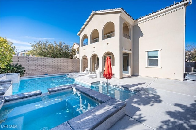 view of swimming pool with a patio area and an in ground hot tub