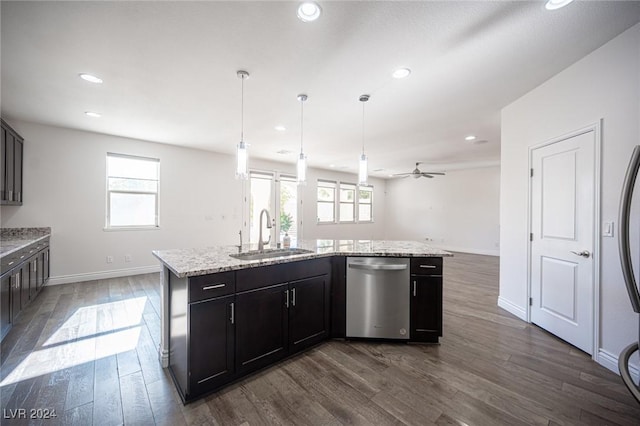 kitchen featuring a wealth of natural light, dishwasher, an island with sink, and sink