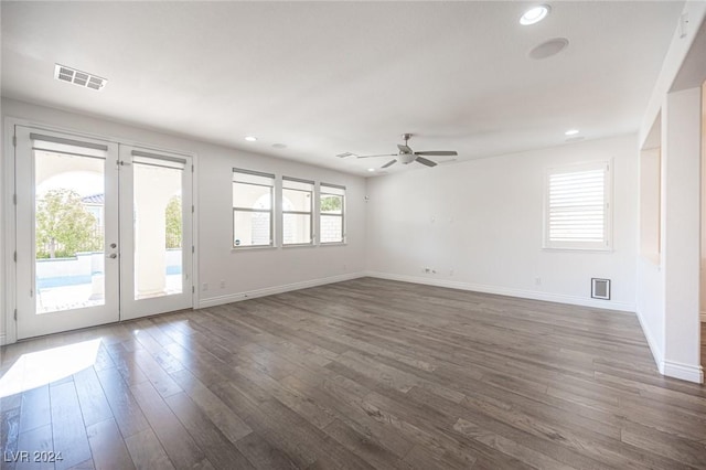 spare room featuring ceiling fan, dark wood-type flooring, and french doors