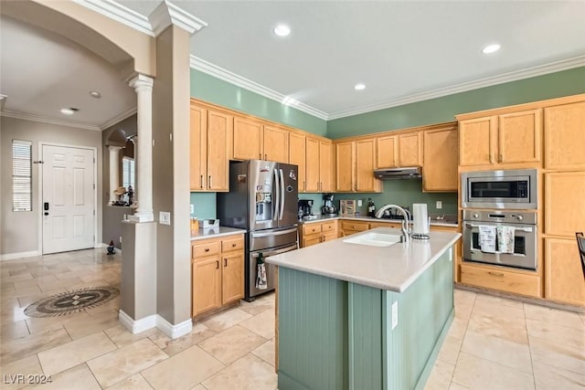 kitchen with a center island with sink, sink, ornamental molding, appliances with stainless steel finishes, and decorative columns