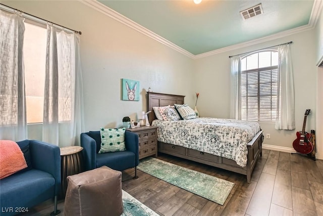 bedroom featuring crown molding and wood-type flooring