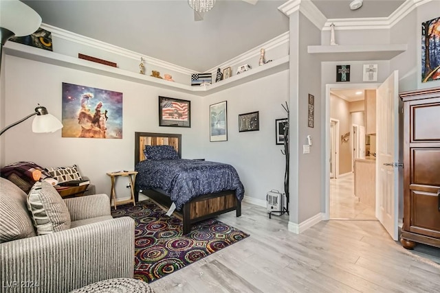 bedroom featuring light hardwood / wood-style flooring and ornamental molding