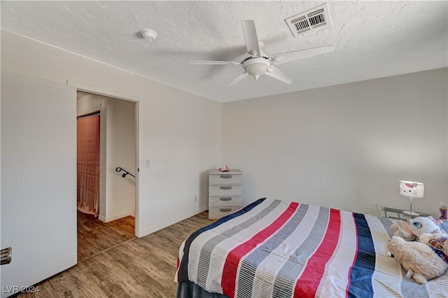 bedroom featuring ceiling fan and hardwood / wood-style flooring