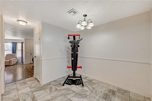 interior details with a chandelier and a textured ceiling