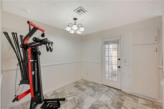 workout area with a chandelier