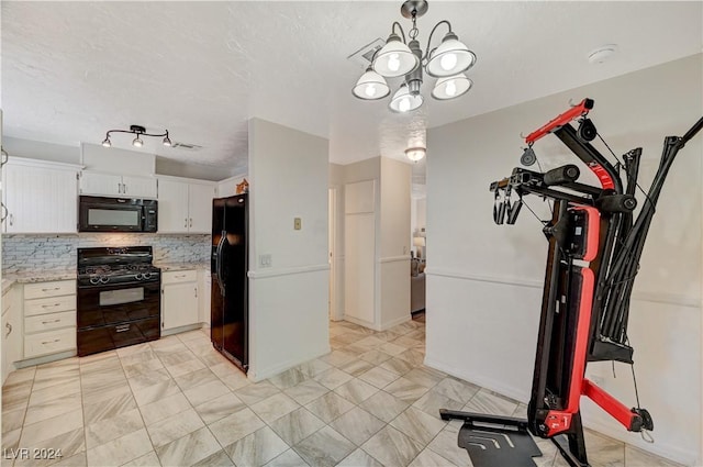 kitchen featuring decorative light fixtures, backsplash, black appliances, white cabinetry, and light stone countertops