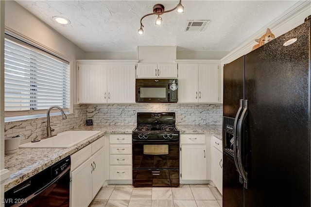 kitchen featuring decorative backsplash, sink, white cabinets, and black appliances