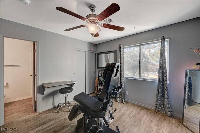 workout area with light hardwood / wood-style flooring