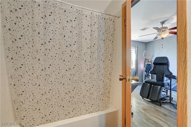 interior space with ceiling fan, shower / bath combination with curtain, and hardwood / wood-style floors