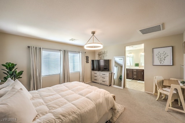 carpeted bedroom with ensuite bathroom