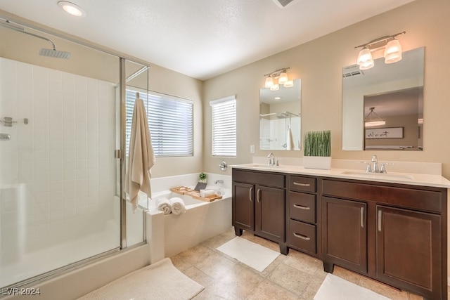 bathroom with tile patterned floors, vanity, and plus walk in shower