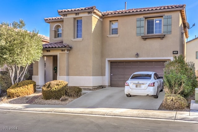 mediterranean / spanish-style home featuring a garage