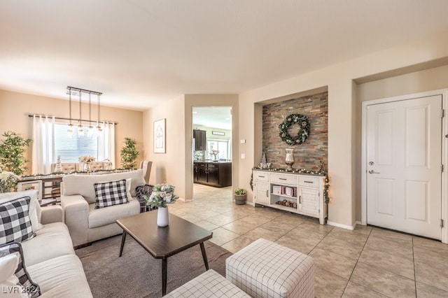 tiled living room with an inviting chandelier