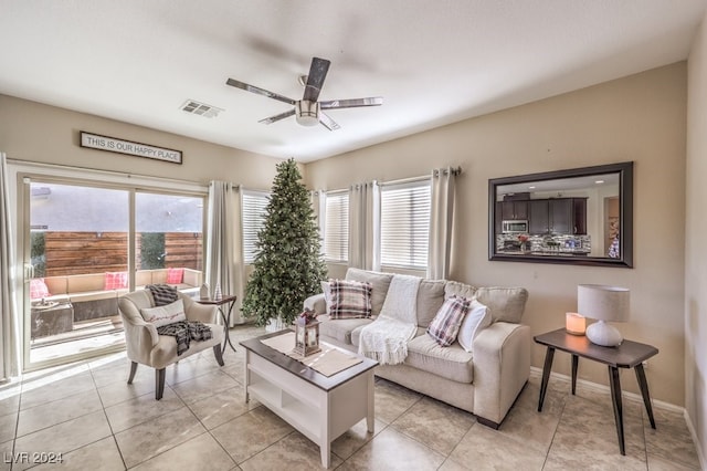 living room featuring ceiling fan and light tile patterned flooring