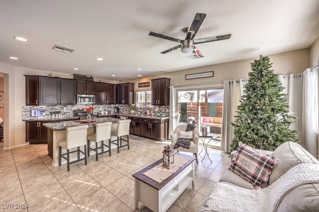 living room featuring ceiling fan and light tile patterned floors