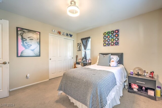 bedroom featuring light carpet and a closet