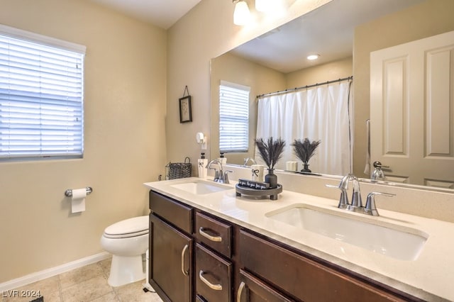 bathroom with tile patterned flooring, vanity, and toilet