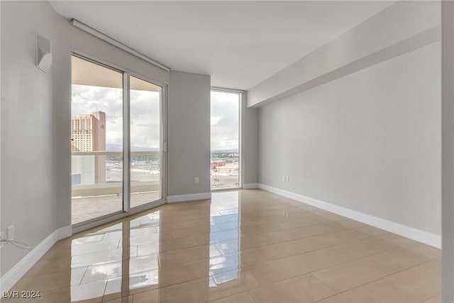 tiled spare room with a wealth of natural light