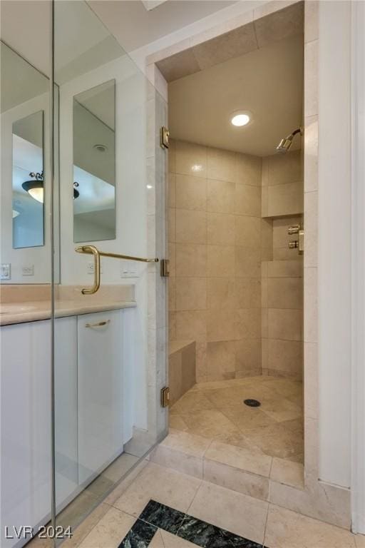 bathroom featuring vanity, tile patterned floors, and walk in shower