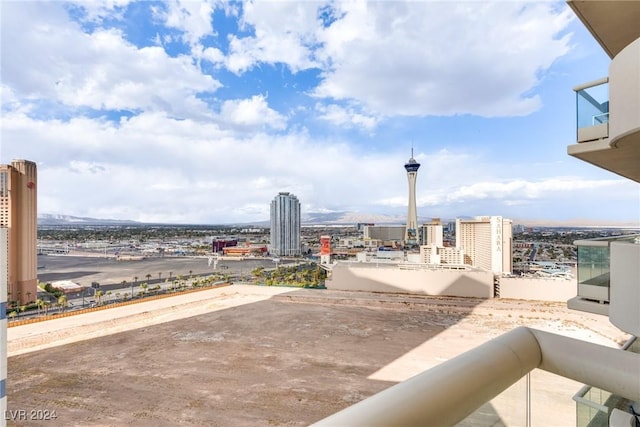 view of patio with a view of city and a balcony