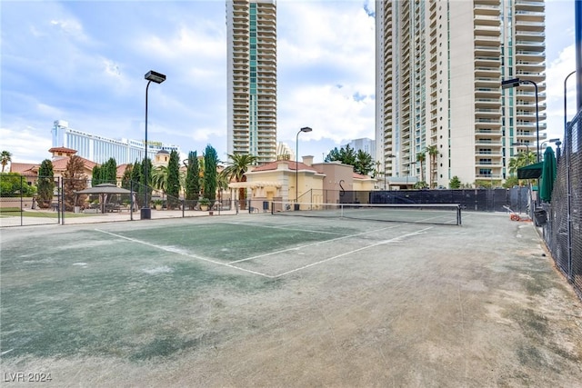 view of sport court featuring fence