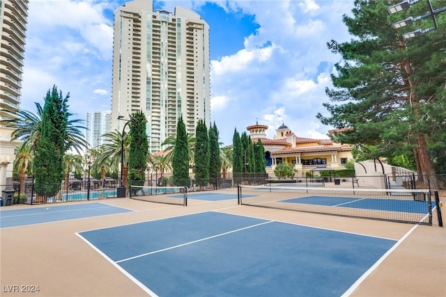 view of tennis court featuring fence