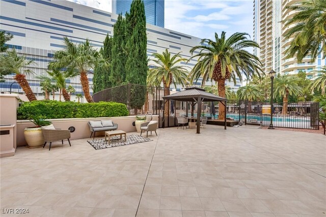 view of patio featuring a gazebo and a community pool